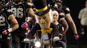 Wake Forest's "Demon Deacon" mascot leads the team on the field before an NCAA college football game against Clemson in Winston-Salem, N.C., Thursday, Oct. 25, 2012. (AP Photo/Chuck Burton)